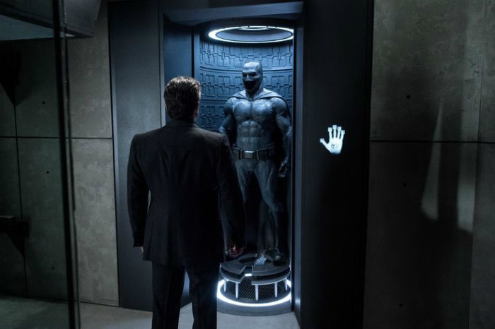 Bruce Wayne looking at Batman suit
